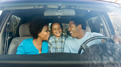 Smiling African family inside the car